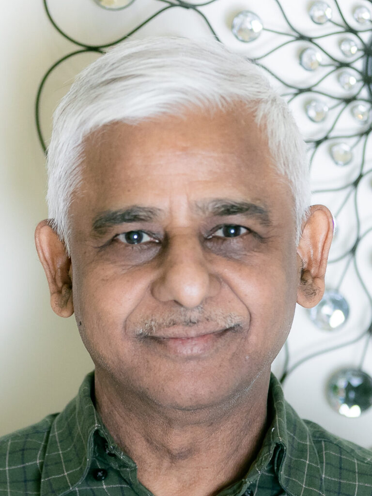 A man with white hair and blue eyes.