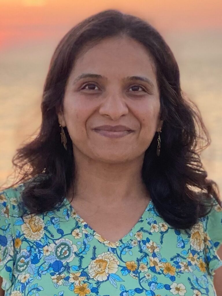 A woman with long hair and a blue shirt.